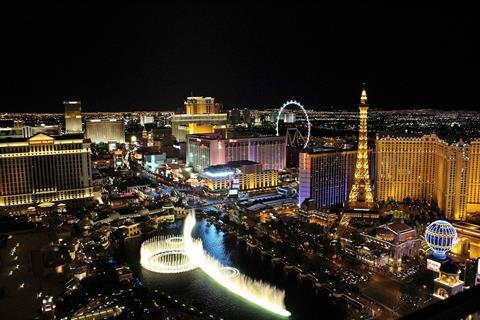 An aerial view of Las Vegas at night-time with casinos, fountains and rides.
